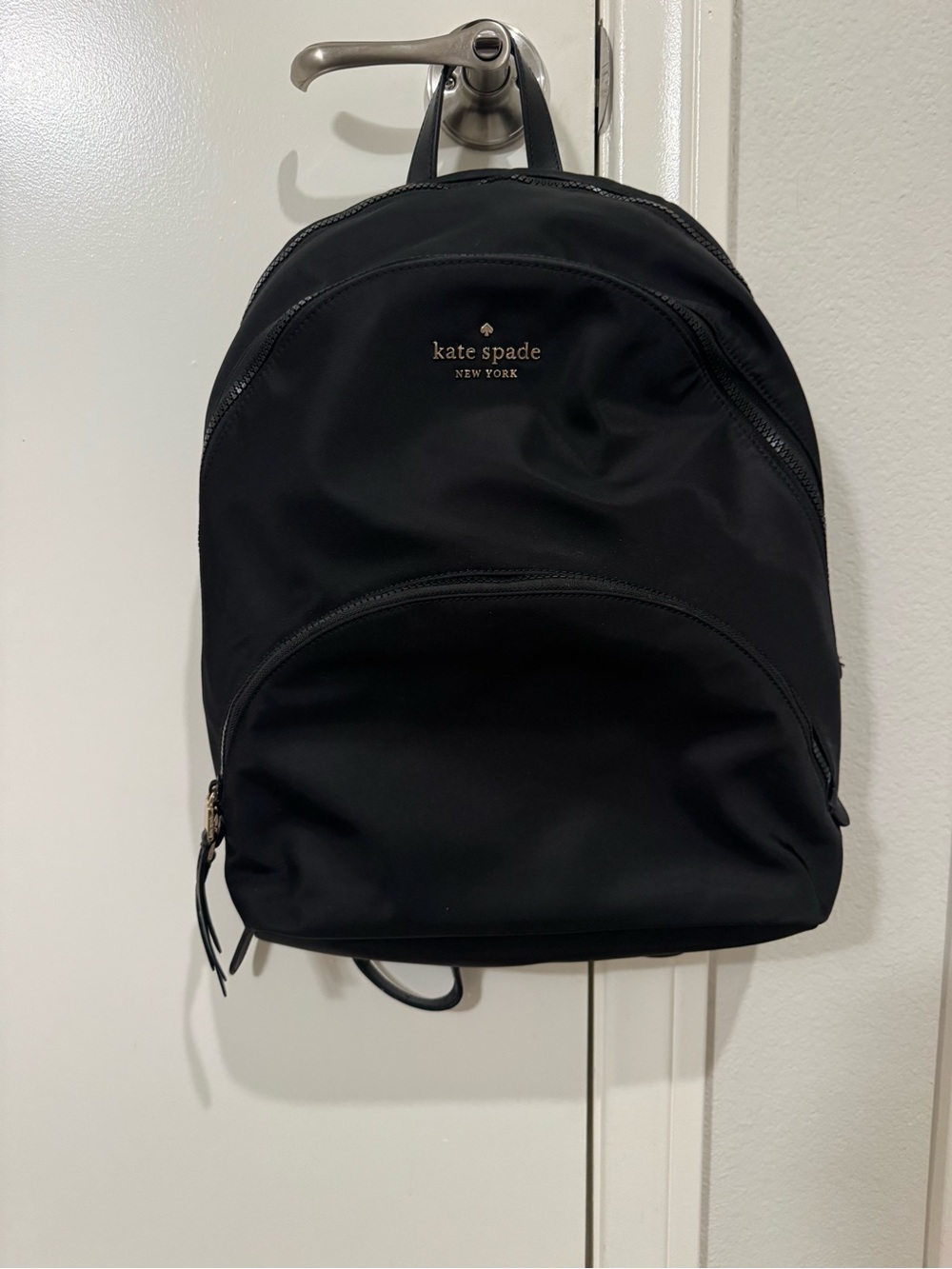 kate spade black nylon backpack with gold-tone logo and zipper